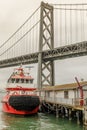 San Francisco Fireboat moored with the Bay Bridge in the background.